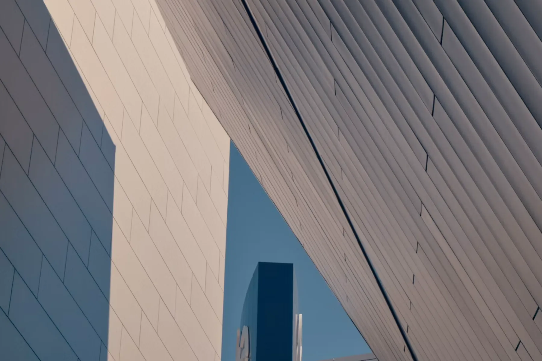 Modern geometric building facade casting angular shadows in Las Vegas, Nevada.
